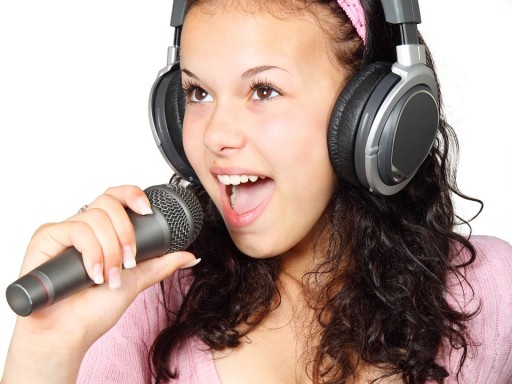Girl singing into a karaoke microphone